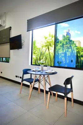 a dining room with a table and two chairs at Beautiful & Cozy Suite 3 min from Paseo Escalon in San Salvador