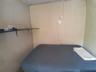a small room with a blue bed and a shelf at Apt Playa kilometro 59, Rural area in ChiltiupÃ¡n