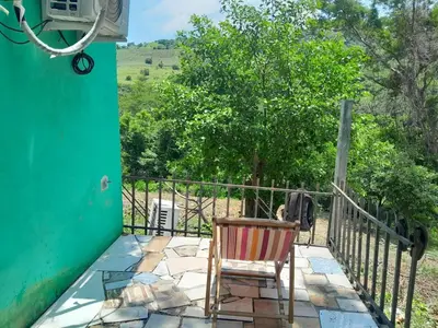 a chair sitting on a porch with a fence at Apt Playa kilometro 59, Rural area in ChiltiupÃ¡n