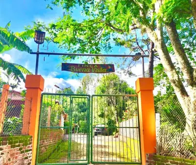 a gate with a street sign on top of it at Comfy Bedroom in a hostal at Coatepeque lake in El Congo