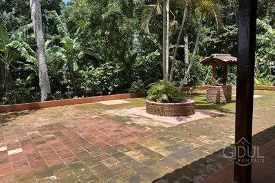 a garden with a brick patio and a gazebo at Cozy Bedroom in a coffee farmn in Coatepeque Lake in Santa Ana