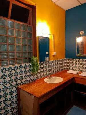 a bathroom with a sink and a mirror at Expresión cultural restaurante y alojamiento in Santa Ana