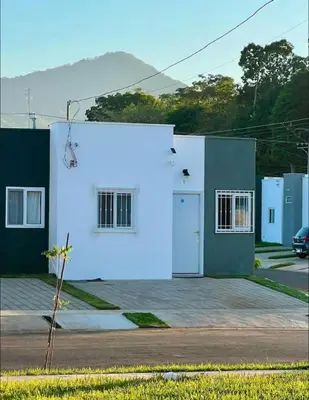 a white building with a blue light on it at Ahuachapan Tiny Rental Homes in Ahuachapán