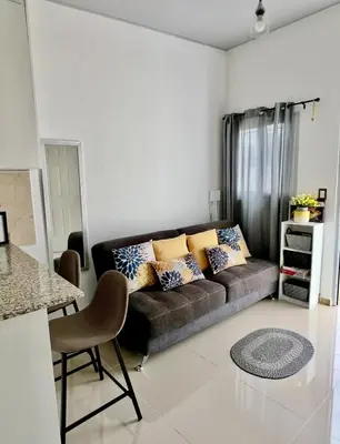 a living room with a couch and a table at Ahuachapan Tiny Rental Homes in Ahuachapán
