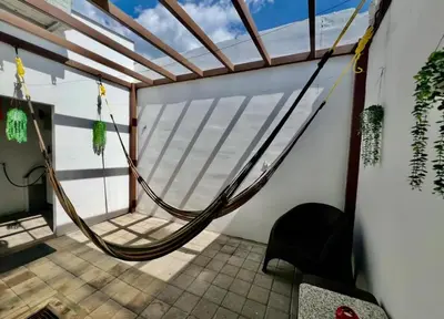 a hammock in a room with a window at Ahuachapan Tiny Rental Homes in Ahuachapán