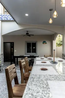 a dining room with a long table and chairs at Dreams of the sea in Playa San Blas