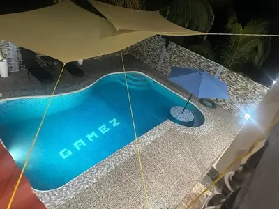 an overhead view of a swimming pool with an umbrella at Dreams of the sea in Playa San Blas