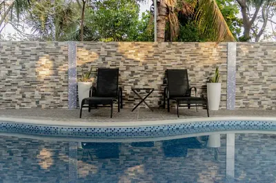 two chairs sitting next to a swimming pool at Dreams of the sea in Playa San Blas