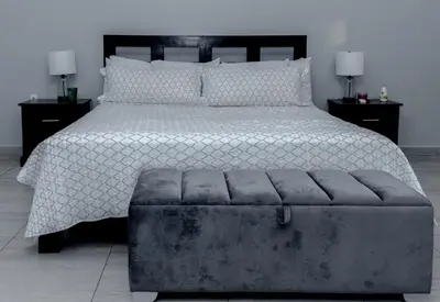 a bedroom with a large bed with a ottoman at Dreams of the sea in Playa San Blas