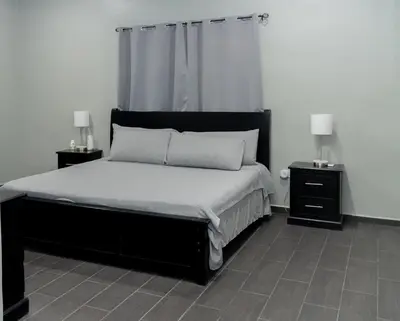 a bedroom with a large bed with two night stands at Dreams of the sea in Playa San Blas