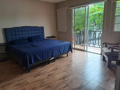 a bedroom with a bed with a blue comforter at Rancho número 50 in La Libertad