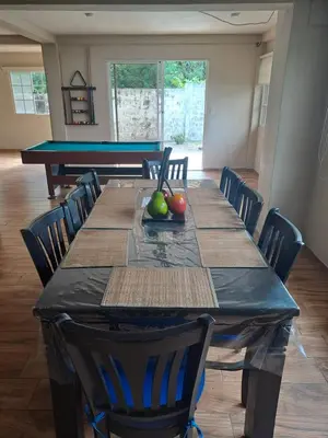 a dining room with a table and a pool table at Rancho número 50 in La Libertad
