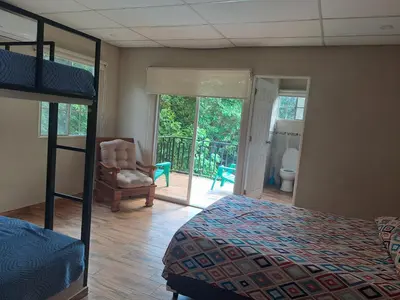 a bedroom with a bunk bed and a balcony at Rancho número 50 in La Libertad