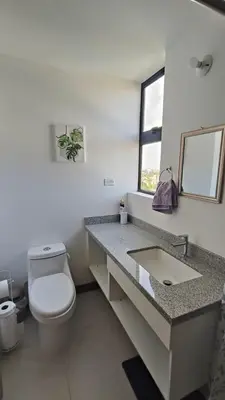 a bathroom with a toilet and a sink at Vista de la capital in San Salvador