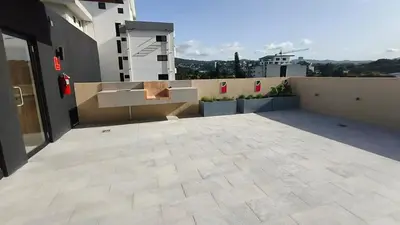 a balcony with a bench on top of a building at Vista de la capital in San Salvador