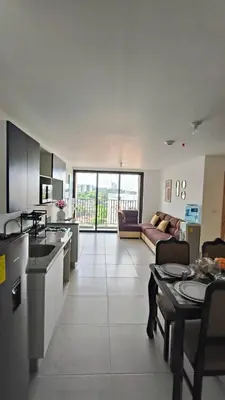 a large kitchen and living room with a couch at Vista de la capital in San Salvador
