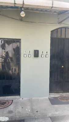 two doors on the side of a building at Conchita House Playa El Tunco in Tamanique