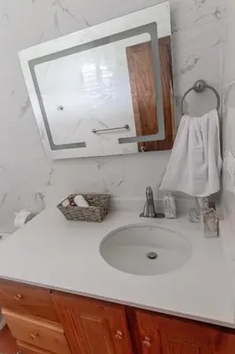 a bathroom counter with a sink and a mirror at Las Golondrinas El Zonte, El Salvador in El Zonte