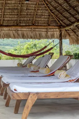 a group of chairs on a hammock on a beach at Las Golondrinas El Zonte, El Salvador in El Zonte