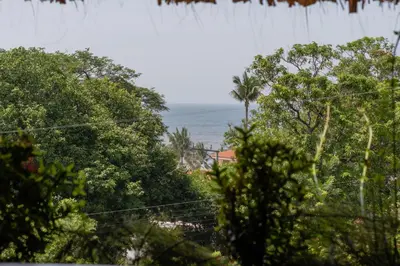 a view of the ocean through the trees at Las Golondrinas El Zonte, El Salvador in El Zonte