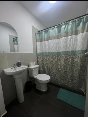a bathroom with a toilet and a sink and a shower at Mini Apartamento in Nueva San Salvador