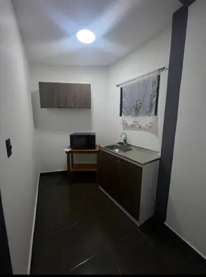 a small bathroom with a sink and a table at Mini Apartamento in Nueva San Salvador