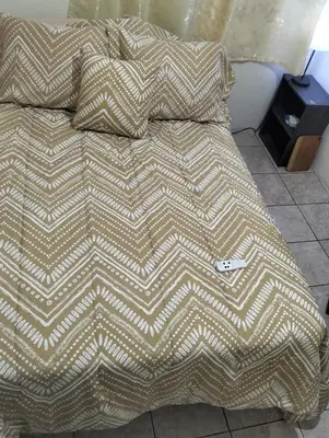a bed with two pillows on top of it at Copinol 68 in San Salvador