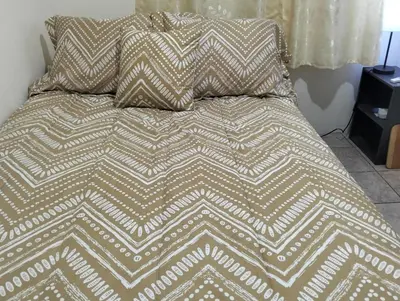 a bed with two pillows on top of it at Copinol 68 in San Salvador