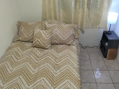 a bed with two pillows on it in a bedroom at Copinol 68 in San Salvador