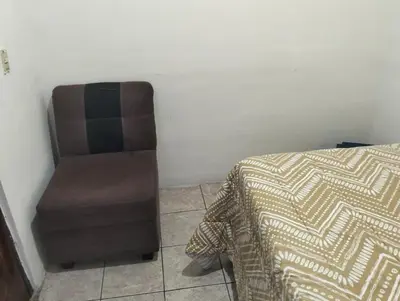 a bed and a chair in a room at Copinol 68 in San Salvador