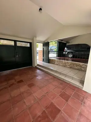 an empty garage with a car parked in a driveway at Casa Santa Elena Fuertevli in San Salvador