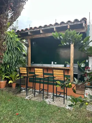 a table with two chairs and a large screen at Casa Santa Elena Fuertevli in San Salvador