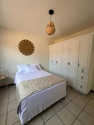 a bedroom with a bed and white cabinets at Casa Santa Elena Fuertevli in San Salvador