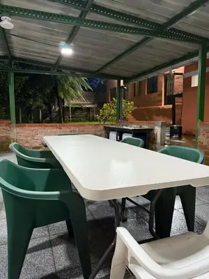 a white table and chairs in a patio at Villa San Carlos in Juayúa