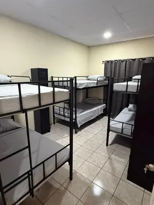 a room with several bunk beds in a room at Villa San Carlos in Juayúa