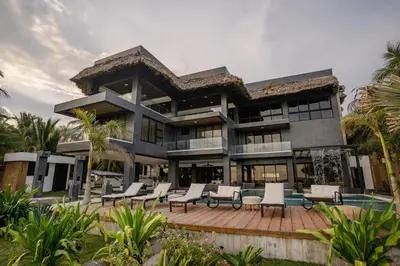 a large house with a patio and chairs at Cardedeu Residence Cangrejera in La Libertad