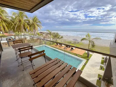 a balcony with benches and a view of the beach at Cardedeu Residence Cangrejera in La Libertad