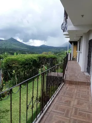 a balcony of a house with mountains in the background at El Balcón de Ataco in Concepción de Ataco