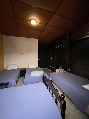 a room with three beds in a room at El Balcón de Ataco in Concepción de Ataco