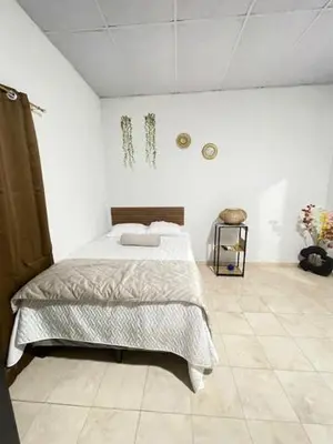 a bedroom with a bed in a white room at La ceiba surf in El Sunzal