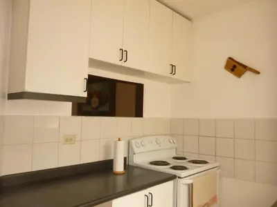 a kitchen with a stove and white cabinets at Apartment with an excellent location by Redondel Masferrer San Salvador, El Salvador in San Salvador