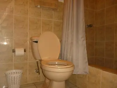 a bathroom with a toilet with a shower curtain at Apartment with an excellent location by Redondel Masferrer San Salvador, El Salvador in San Salvador