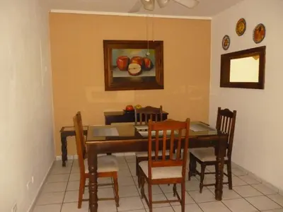 a dining room table with chairs and a painting of apples at Apartment with an excellent location by Redondel Masferrer San Salvador, El Salvador in San Salvador