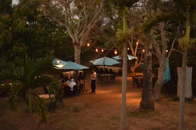 a group of people sitting at tables under umbrellas at Gran Bonanza Hotel in Alegría