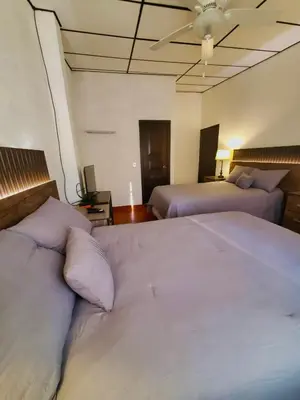 a bedroom with two beds and a ceiling at Gran Bonanza Hotel in Alegría