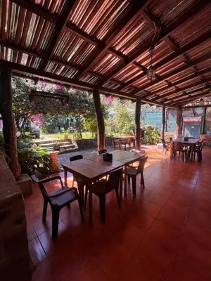 a wooden table and chairs in a pavilion at Gran Bonanza Hotel in Alegría