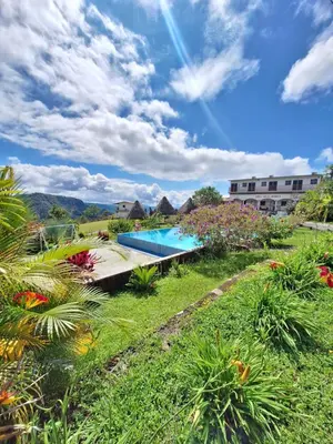a resort with a swimming pool and some plants at Hotel y restaurante villa marquez in Perquín