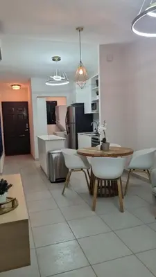 a kitchen with a table and chairs in a room at Cozy House! San Miguel in San Miguel