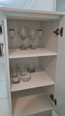 a shelf with wine glasses and bowls on it at Cozy House! San Miguel in San Miguel