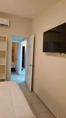a bedroom with a flat screen tv on the wall at Cozy House! San Miguel in San Miguel